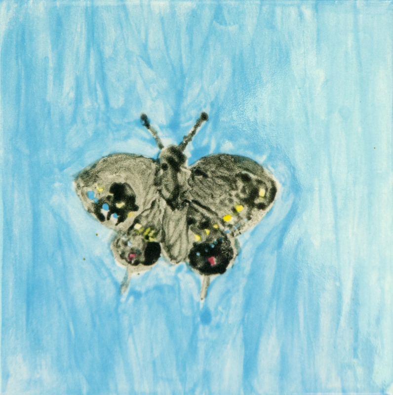 Painting of a black swallowtail butterfly with outstretched wings, decorated with small yellow, blue, and pink spots, set against a light blue background