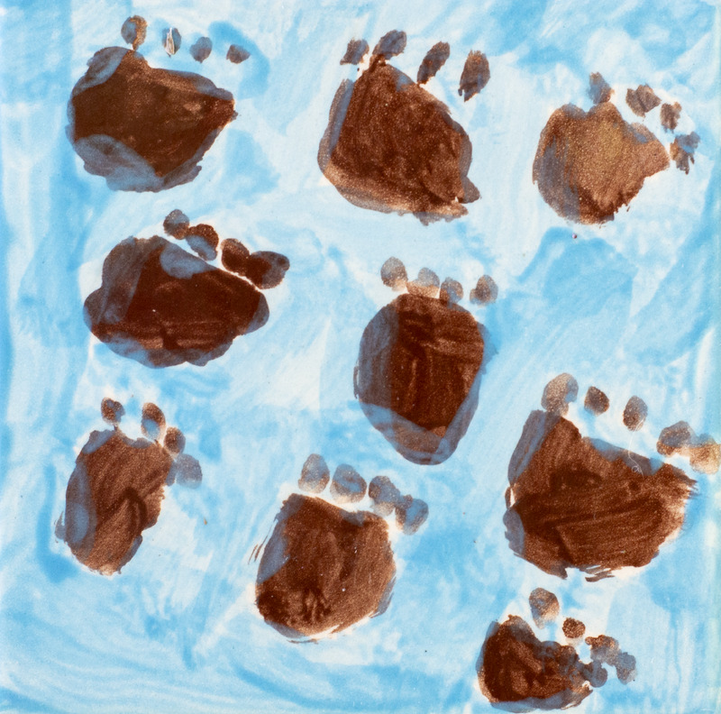 Painting of brown animal tracks in blue background.