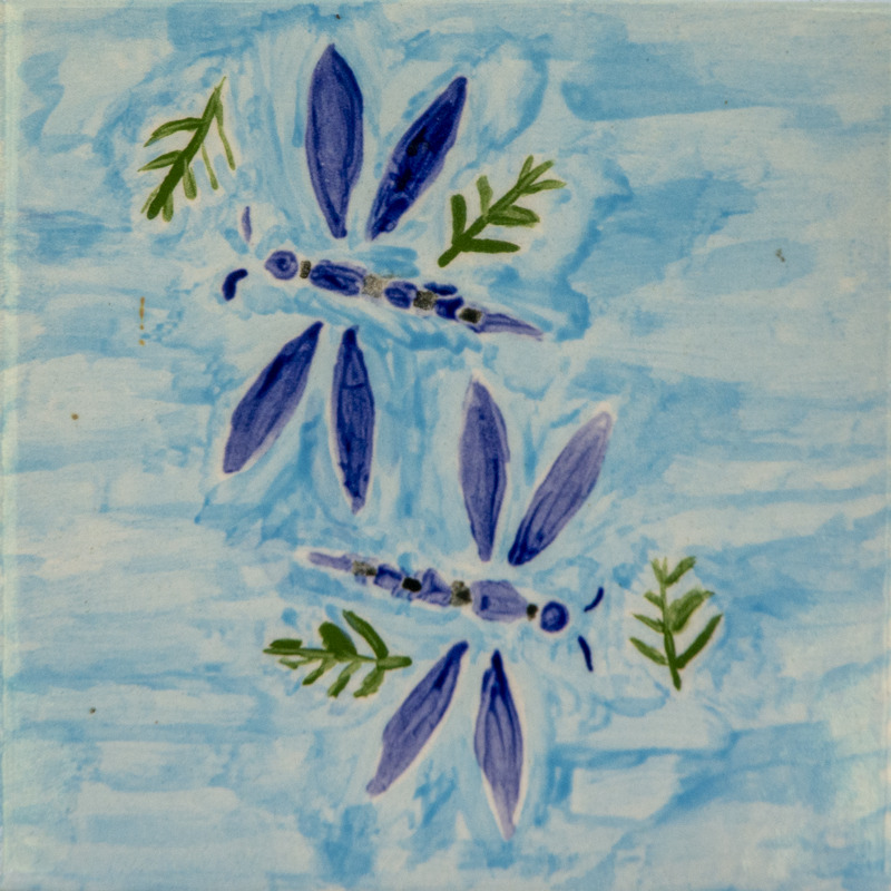 Painting of two blue dragonflies flying against a light blue sky with small green leaf shapes nearby.