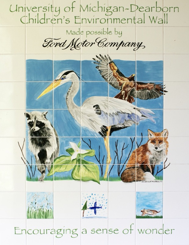 A mural featuring a raccoon, heron, hawk, fox, plants, and water on white tiles. Text reads: University of Michigan-Dearborn Children’s Environmental Wall, Made possible by Ford Motor Company. Encouraging a sense of wonder.