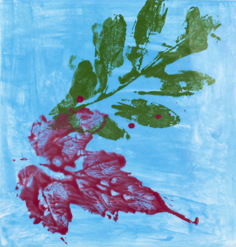 Two red and green leaf prints against blue painted background.