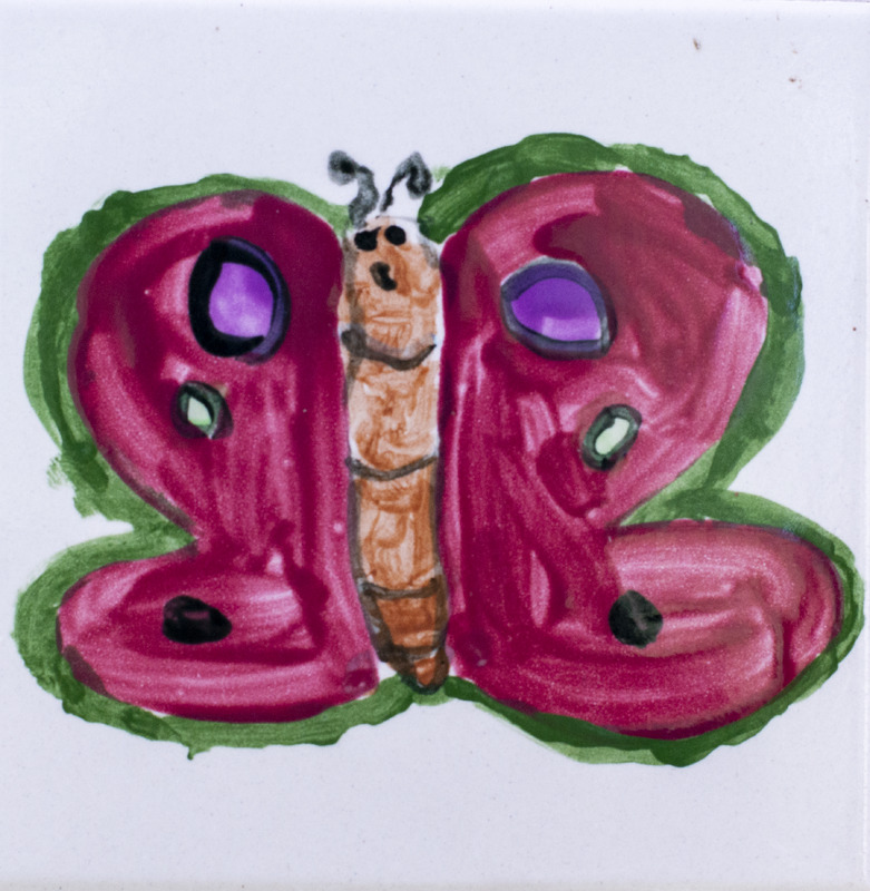 Painting of butterfly with red wings and colorful spots.