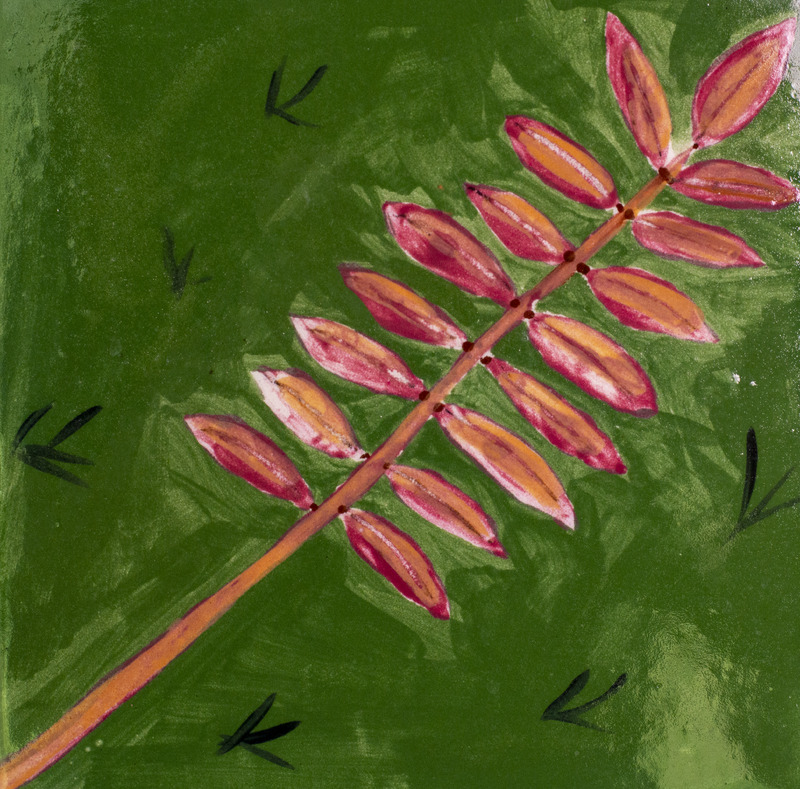 Painting of a brown branch lined with small red leaves laying on grass.